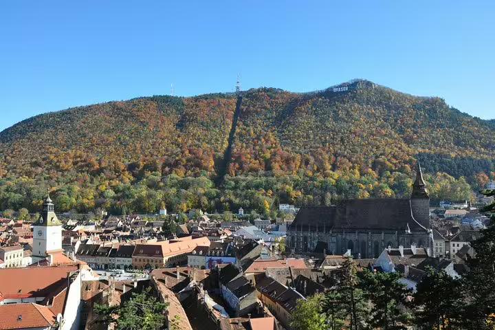 Aerial view of Brasov old town with Black Church and Tampa Mountain in autumn
