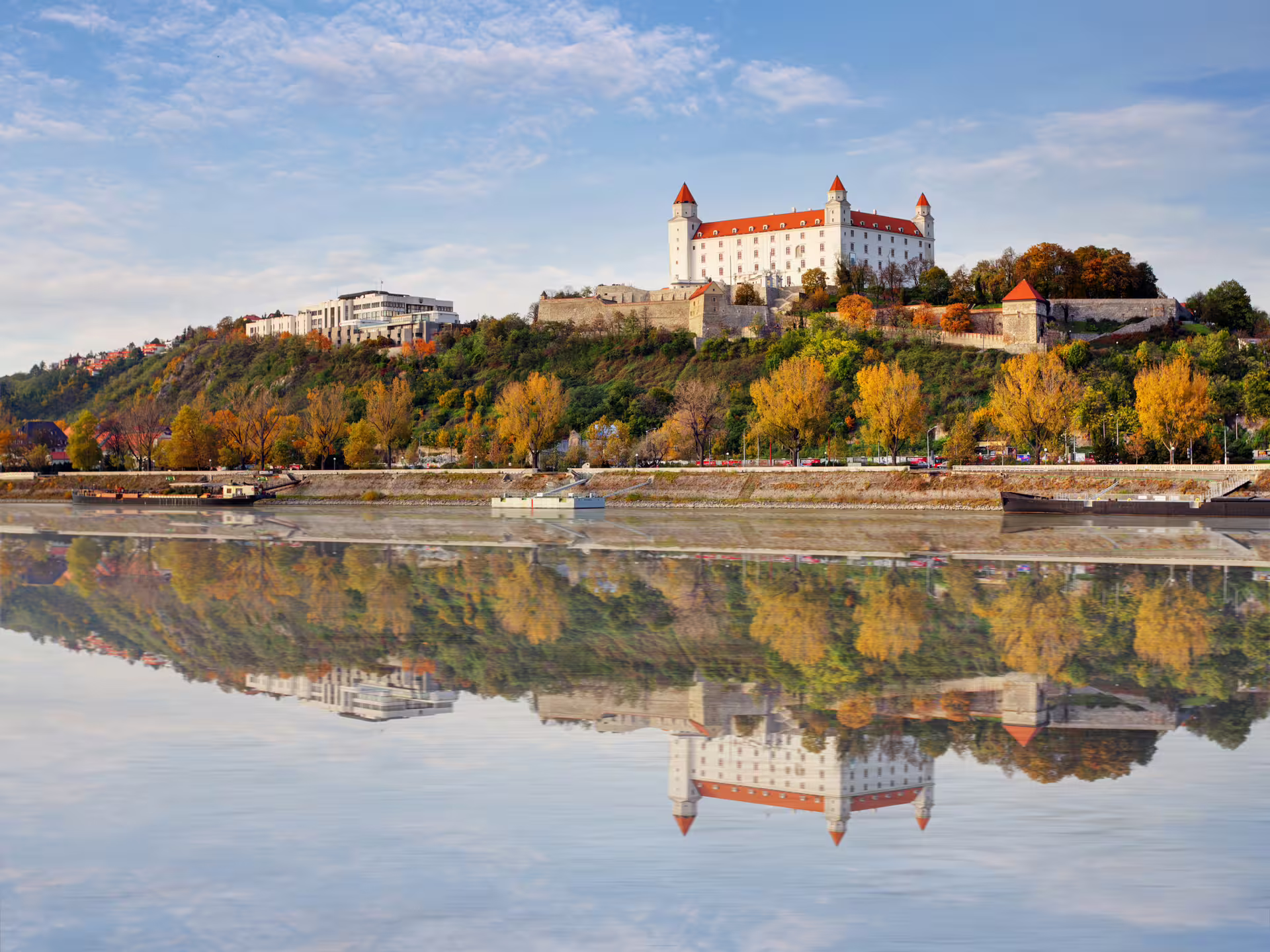 Bratislava Castle reflected in the Danube River in autumn, highlight of 1-day walking tour with multilingual audioguide