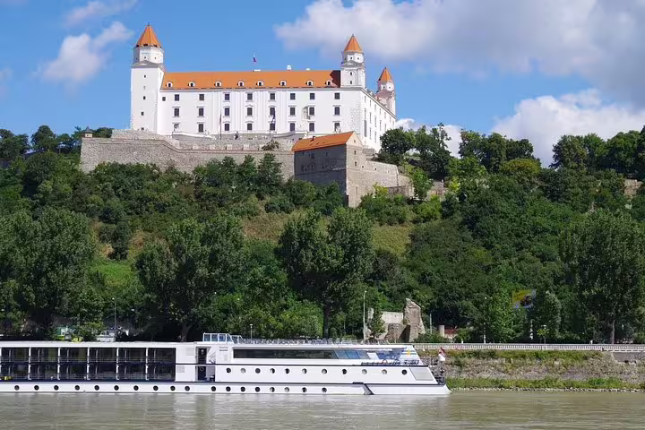 Scenic view of Bratislava Castle overlooking the Danube River, perfect for a private day trip from Vienna to explore Slovakia's history.
