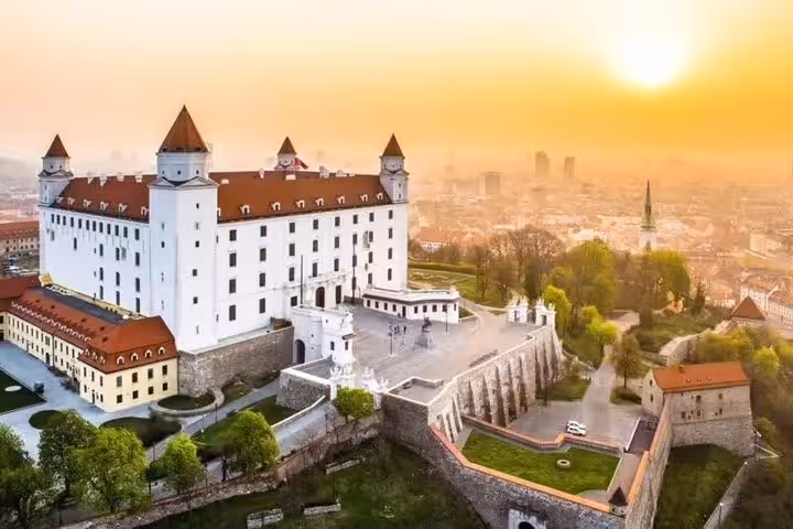 Bratislava Castle overlooking the Danube at sunrise, scenic stop on Vienna to Budapest private one-way transfer