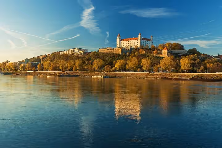 Bratislava Castle reflected on the Danube at sunset, scenic view on Vienna to Bratislava and Budapest day tour