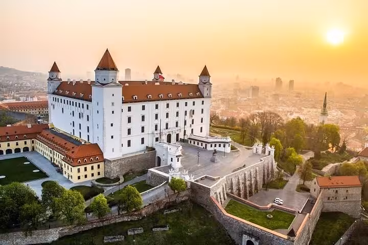 Bratislava Castle at sunrise overlooking the city, highlight of a private day tour from Vienna to Bratislava