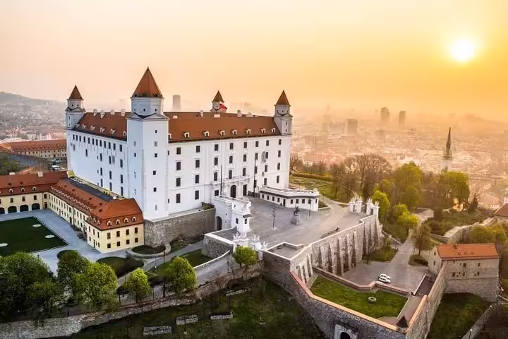 Bratislava Castle at sunset overlooking the city, highlight stop on a private tour from Vienna to Slovakia