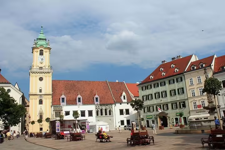 Historic Bratislava city square with charming architecture and iconic clock tower, ideal for day trips from Vienna.