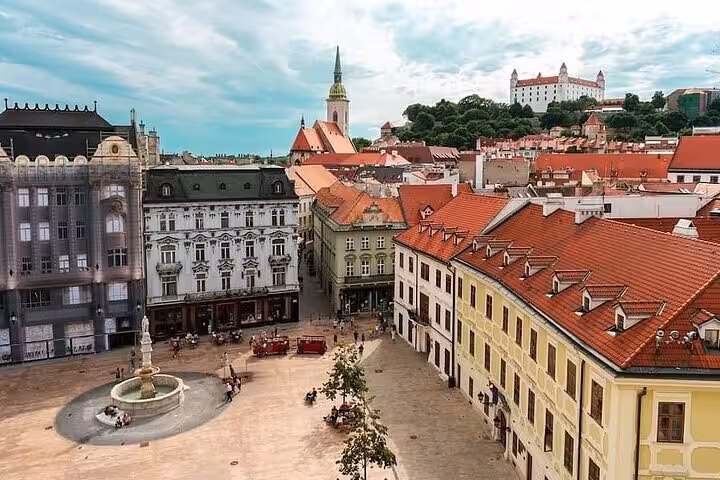 Bratislava Old Town Main Square with red rooftops and castle, Vienna to Bratislava private day tour