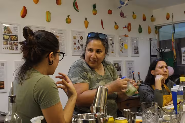 Participants engage in hands-on cocktail-making class, learning to mix drinks at Ipanema Beach bar.