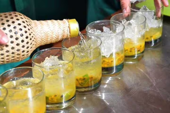 Preparing traditional Brazilian cocktails with fresh passion fruit and cachaça during a cooking class in Rio de Janeiro.