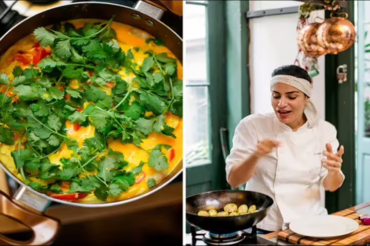 Chef instructs students while preparing a colorful Brazilian dish garnished with fresh cilantro in Rio de Janeiro.