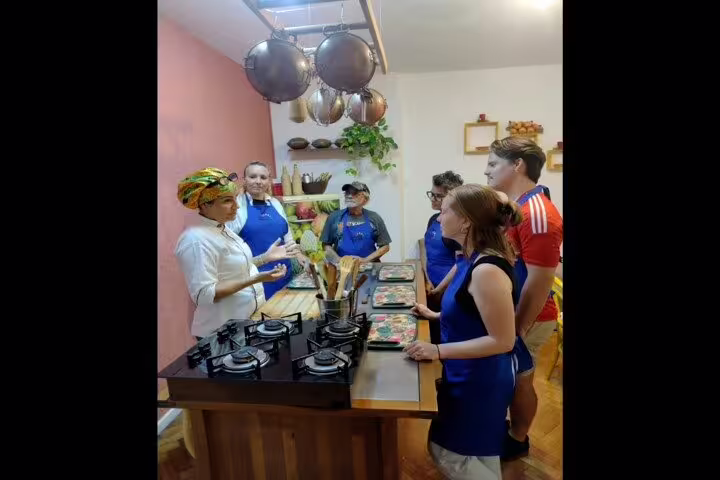 Instructor guides participants in Brazilian culinary techniques during a cooking class in Rio de Janeiro.