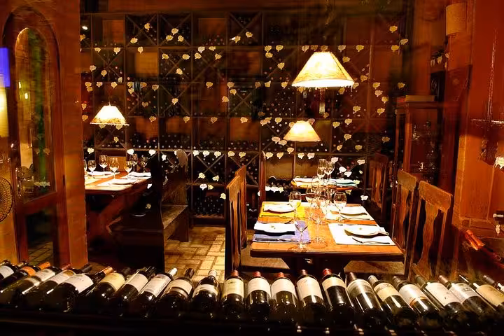 Cozy Brazilian diner with wooden tables, wine rack, and warm lighting for a traditional dining experience.