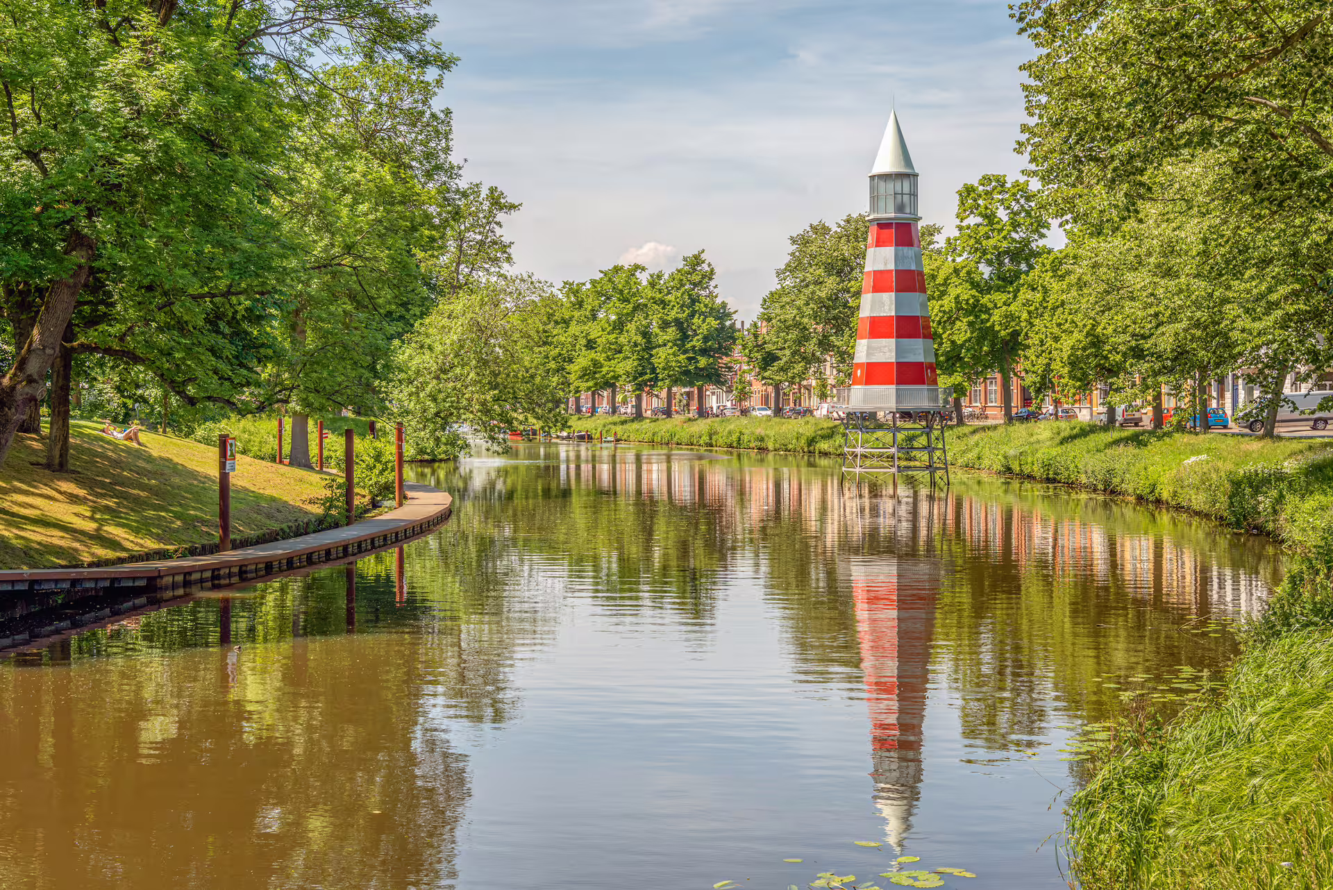 Breda canal with red-and-white lighthouse landmark, a scenic stop on the Breda 1-day audioguide walking tour