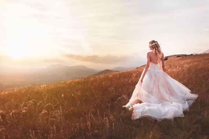 Bride in flowing gown at golden sunset, dreamy Venice elopement-style wedding photography in Italy