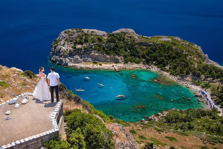 Bride and groom overlooking a stunning coastal view during a professional photoshoot in Rhodes.