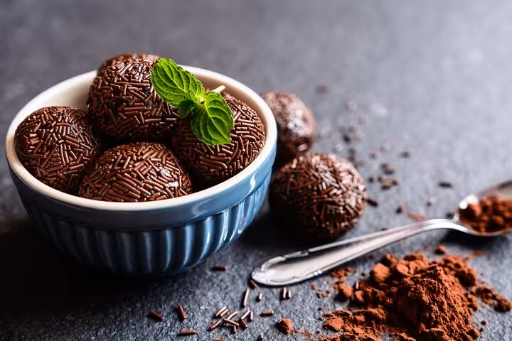 Delicious brigadeiros topped with chocolate sprinkles, a sweet treat you'll make in our Rio seafood cooking class.
