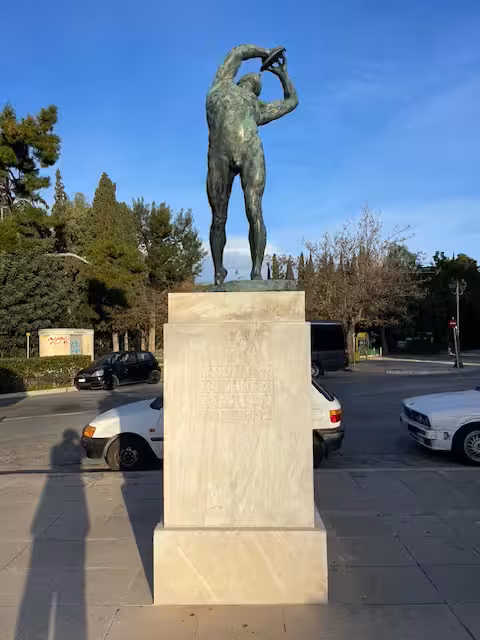 Bronze athlete statue in central Athens on a private panorama city tour with Cape Sounio day trip