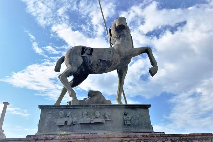 Bronze horse statue at Pompeii under a blue sky, highlighting ancient Roman art on the Amalfi Coast tour.