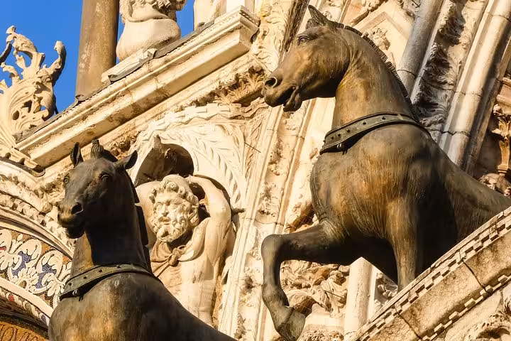 Close-up of the bronze Horses of St. Mark at St. Mark's Basilica, highlighting intricate details for guided tour enthusiasts.