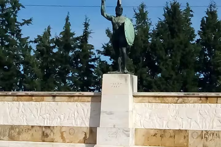 Bronze warrior statue at Delphi archaeological site stop on private day trip from Athens with dinner