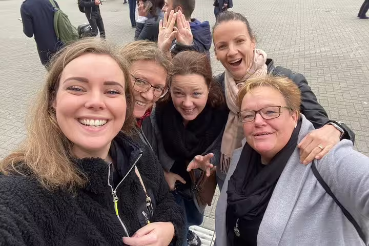 Group selfie on a Bruges self-guided e-scavenger hunt, team solving clues on a flexible walking tour