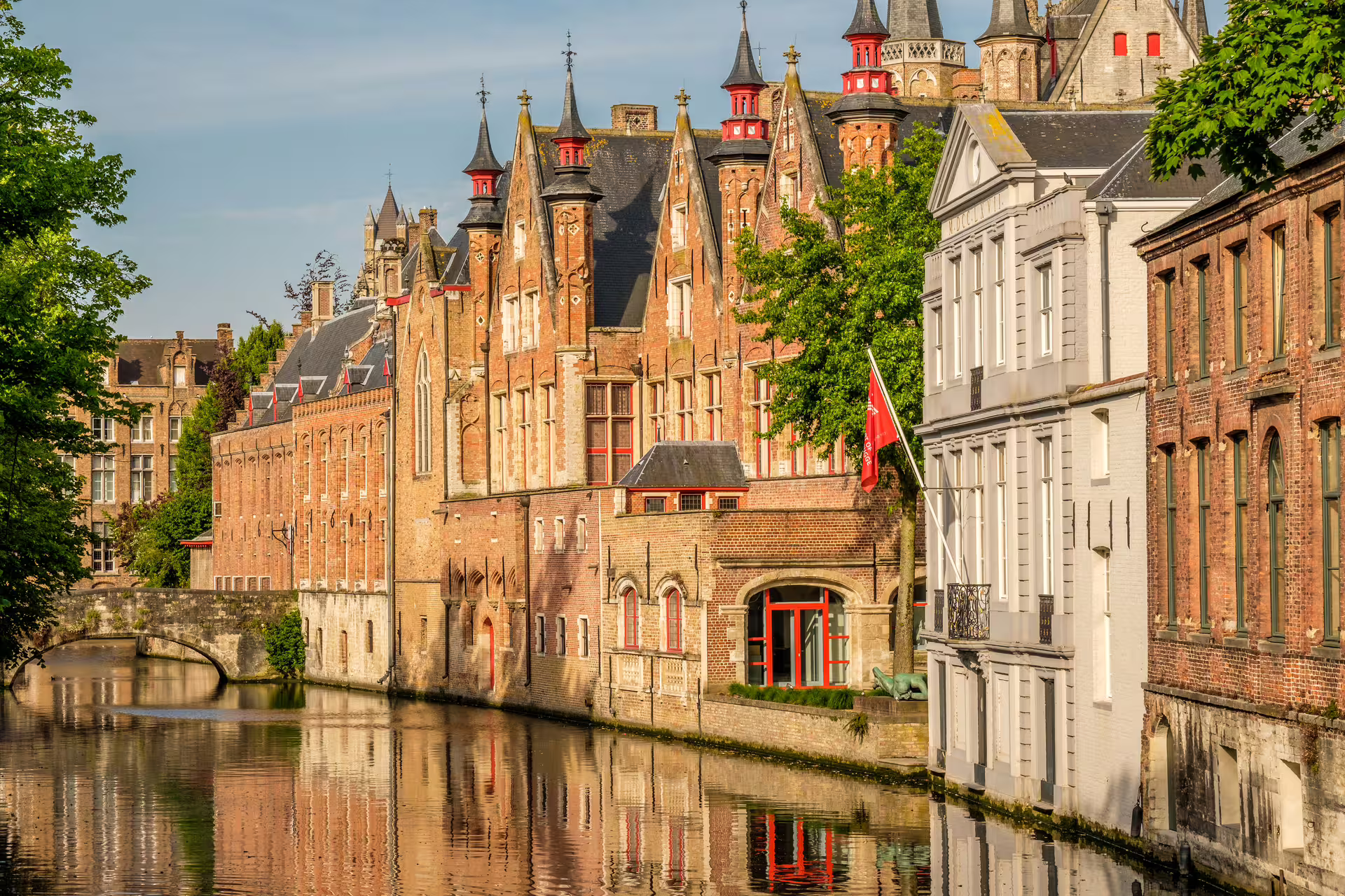 Scenic view of Bruges' historic architecture along a tranquil canal, perfect for a private walking tour in Flanders.