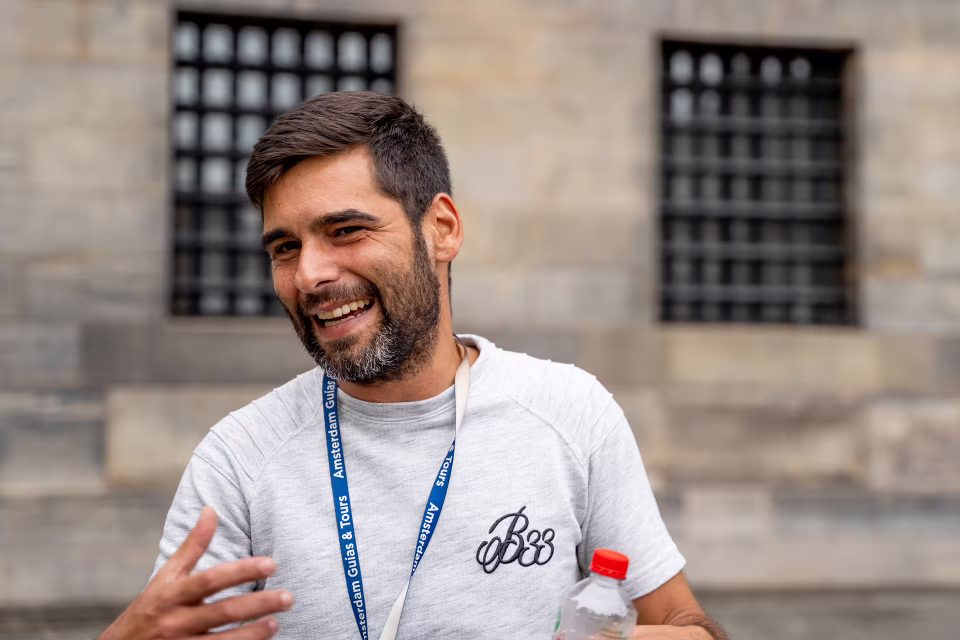 Friendly tour guide engaging with guests during a private walking tour of Bruges, showcasing the charm of Flanders.