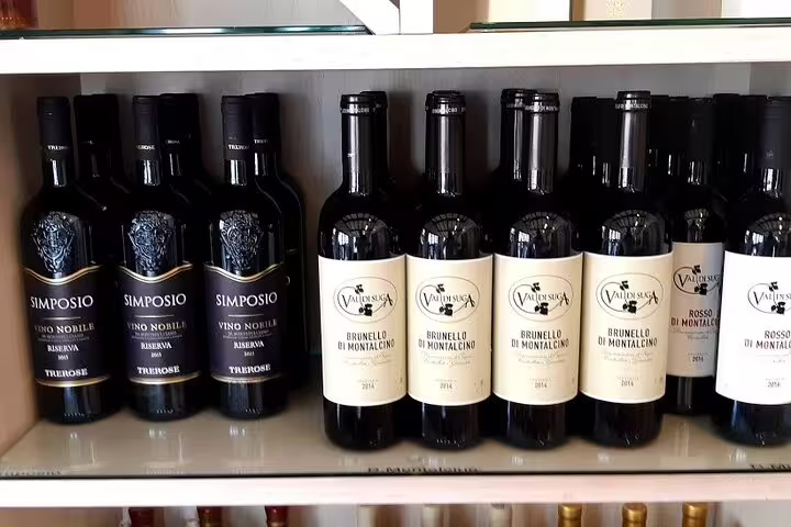 Bottles of Brunello di Montalcino and Tuscan reds displayed in a local winery shop on a Siena and Chianti tasting tour
