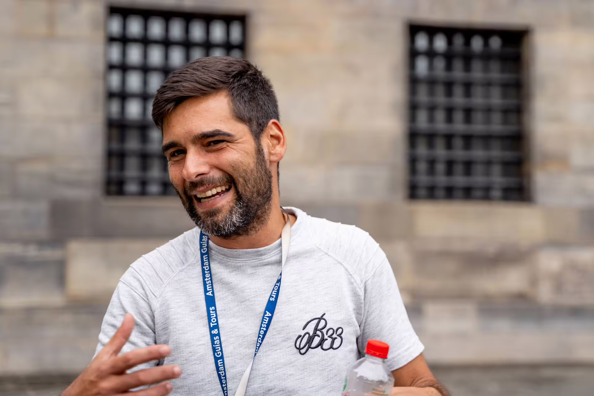 Smiling tour guide in Brussels during a private walking tour, engaging visitors with stories of the unexpected European city.