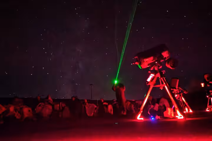Laser-guided astronomy talk with glowing telescope at Bryce Canyon stargazing adventure under dark skies