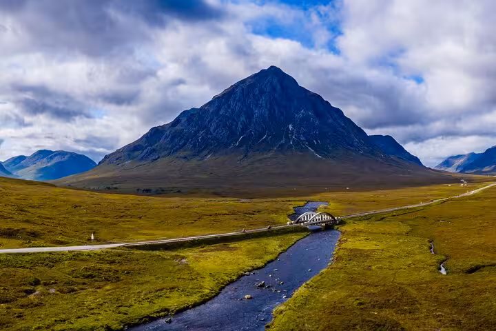 Buachaille Etive Mor towering over River Coupall bridge on the Glencoe and Scottish Highlands day tour