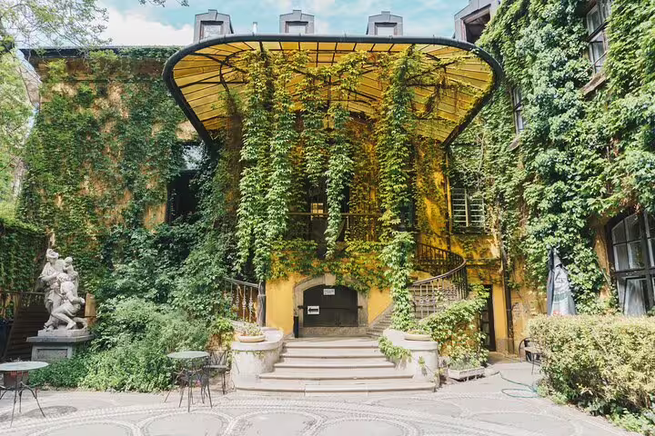 Ivy-covered courtyard cafe in Budapest’s Jewish Quarter, trendy stop on a private modern city tour