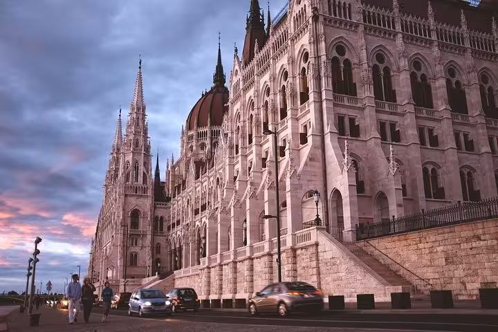 Hungarian Parliament Building at dusk on the Danube, highlight of a Budapest private day trip from Vienna
