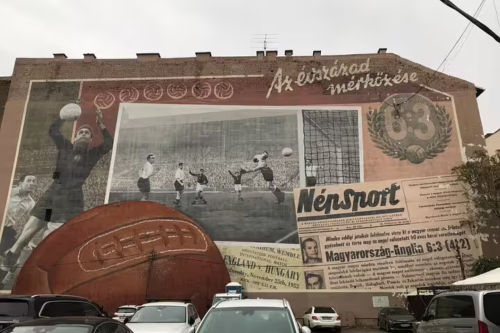 Budapest street art walking tour highlight: huge football-themed mural on building wall in the city