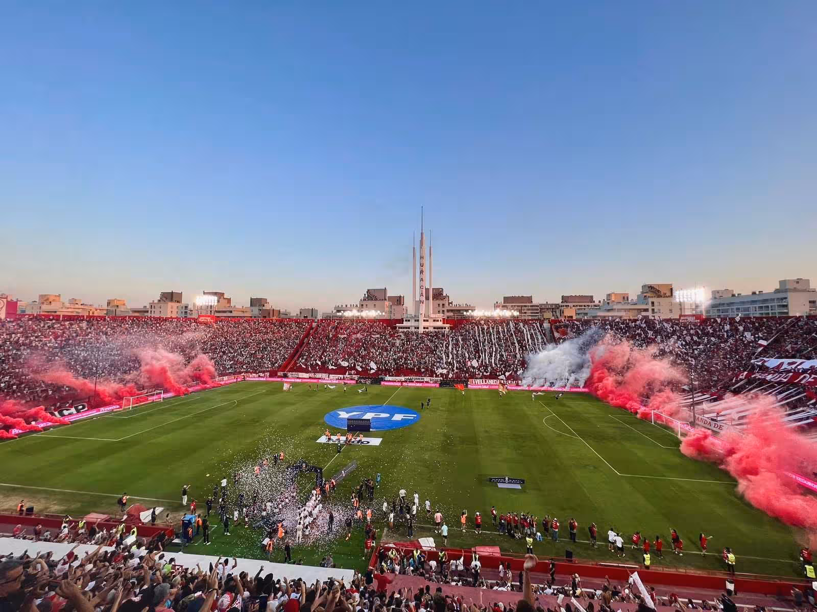 Packed Buenos Aires football stadium with red smoke and confetti, join a local matchday experience tour