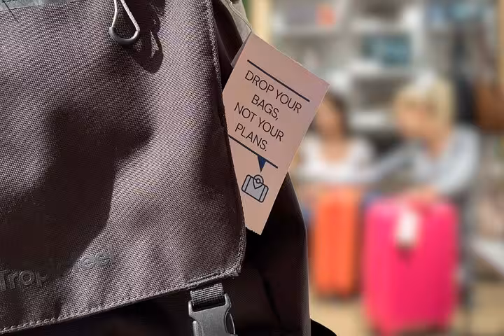 Close-up of travel bag tag saying drop your bags, ideal for Buenos Aires luggage storage booking