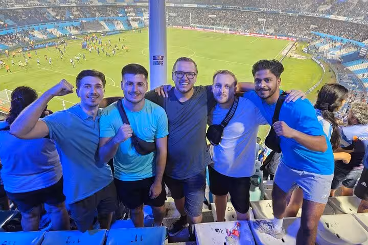 Friends celebrate in the stands at a Buenos Aires soccer matchday experience with local fan guide