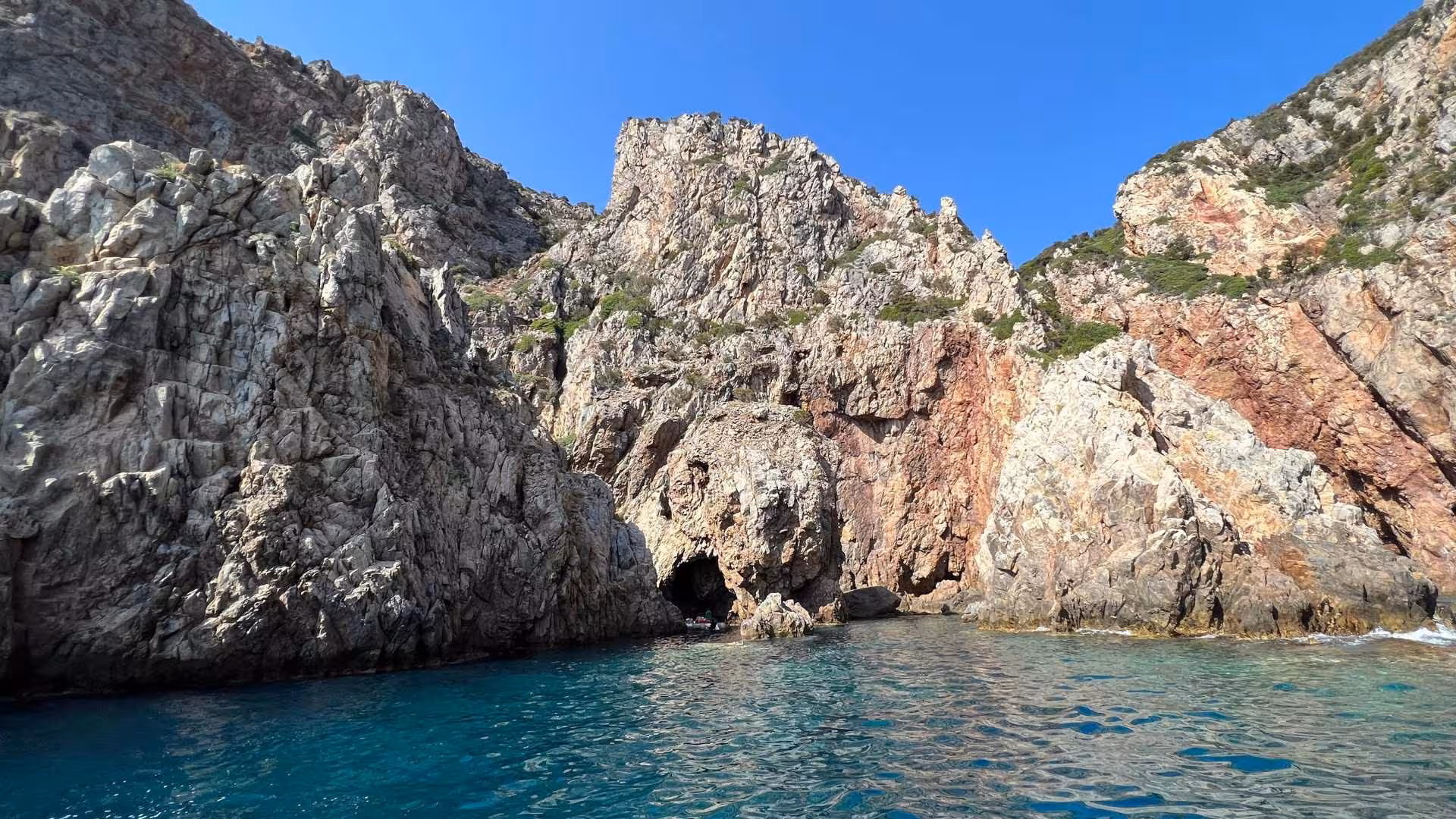 Stunning rocky coastline with clear turquoise waters on the Pan di Zucchero and Porto Flavia dinghy tour.