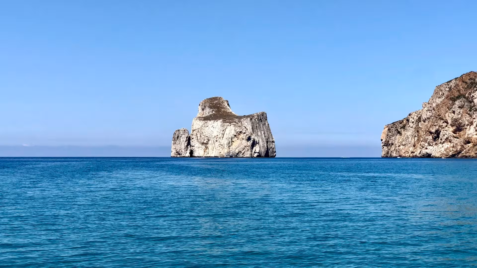 Marvel at the iconic Pan di Zucchero rock formation on our Buggerru dinghy tour, a stunning Sardinian landmark.