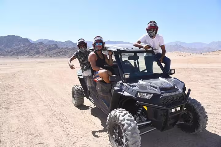 Group riding a 4x4 buggy on open Sinai desert plains during Sharm El Sheikh double buggy adventure safari tour