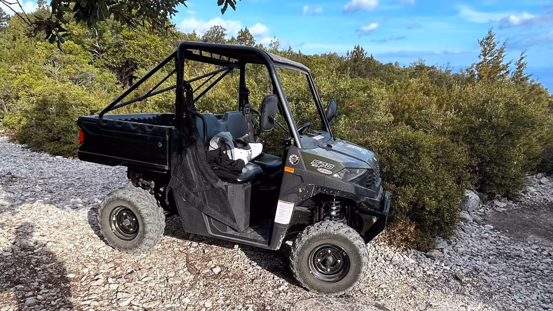 Close-up of a buggy parked on a rugged path amidst dense foliage, ideal for a Punta Salinas adventure tour.