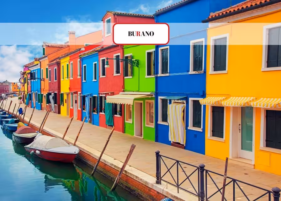 Brightly painted buildings along a canal in Burano, Italy, highlight the island's famous colorful architecture.