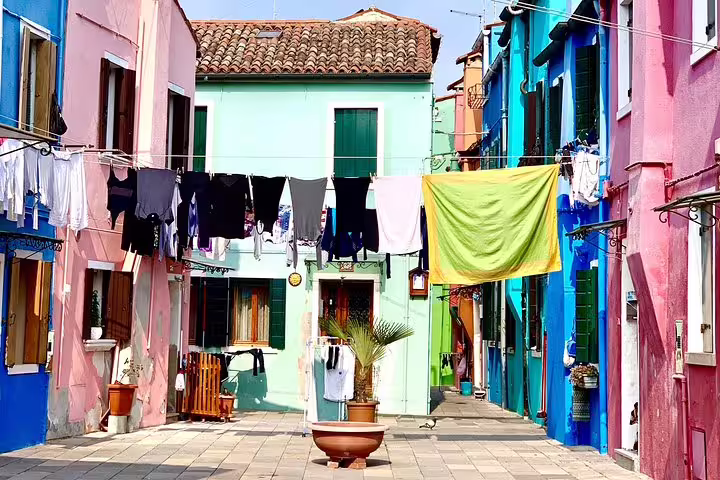 Vibrant Burano street with colorful houses and laundry hanging, capturing the essence of local island life.