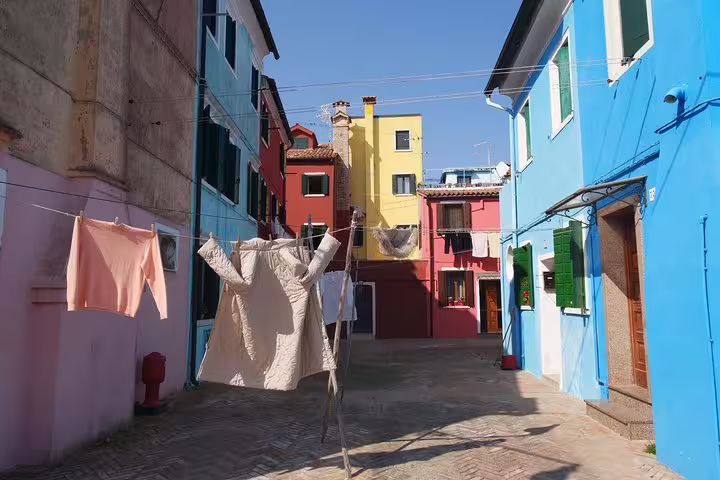 Colorful Burano street scene on private Grand Canal boat tour to Murano and Burano with lunch included