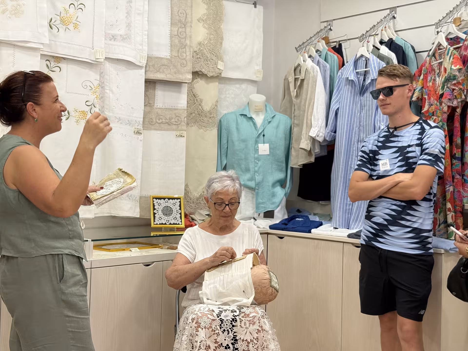 Elderly artisan demonstrating traditional Burano lace-making, offering an authentic cultural experience in Venice.