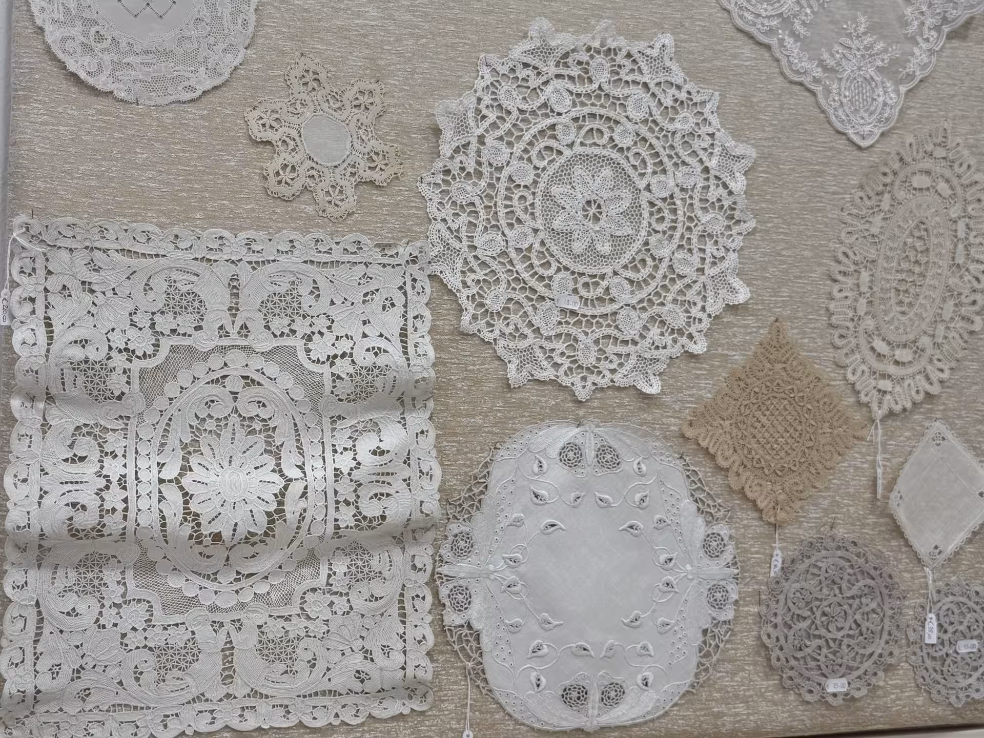 Exquisite Burano lace patterns on display, showcasing intricate craftsmanship as part of the Grand Tour itinerary.