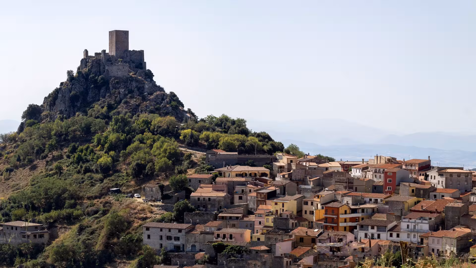 Scenic view of a hilltop castle and village in Burgos, highlighting cultural heritage.