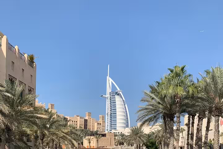 Burj Al Arab view from Madinat Jumeirah with palm trees, stop on Dubai private half-day city tour