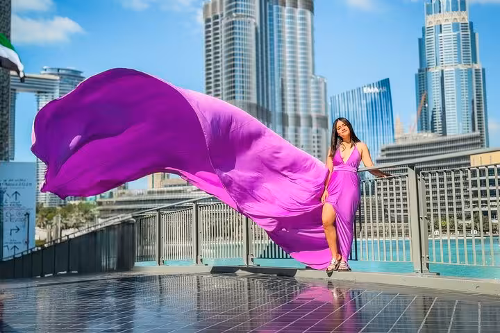 Model in a flowing purple dress captured in front of Burj Khalifa, ideal for Instagram videography and photography.