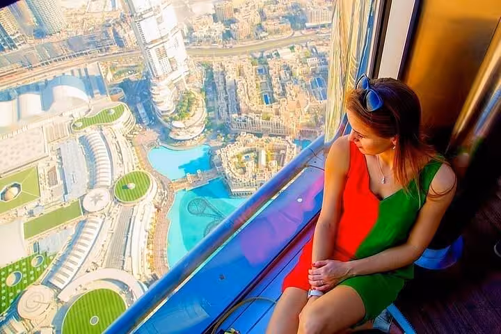 Visitor enjoying Dubai skyline views from Burj Khalifa observation deck with The Roof Top Meal ticket package