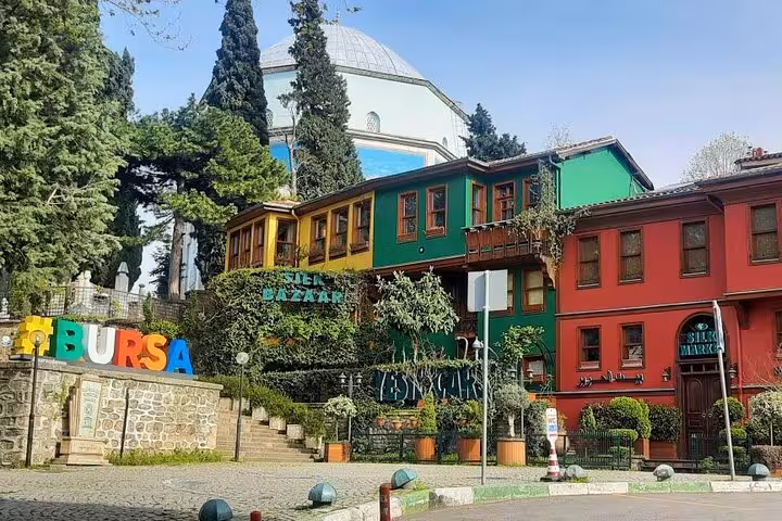 Colorful Ottoman houses and Bursa sign at Tophane, a highlight on Bursa & Uludag day tour from Istanbul