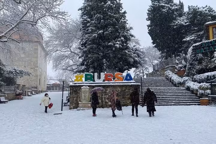 Snowy Bursa city center with colorful BURSA sign and steps, winter Uludag tour from Istanbul with lunch